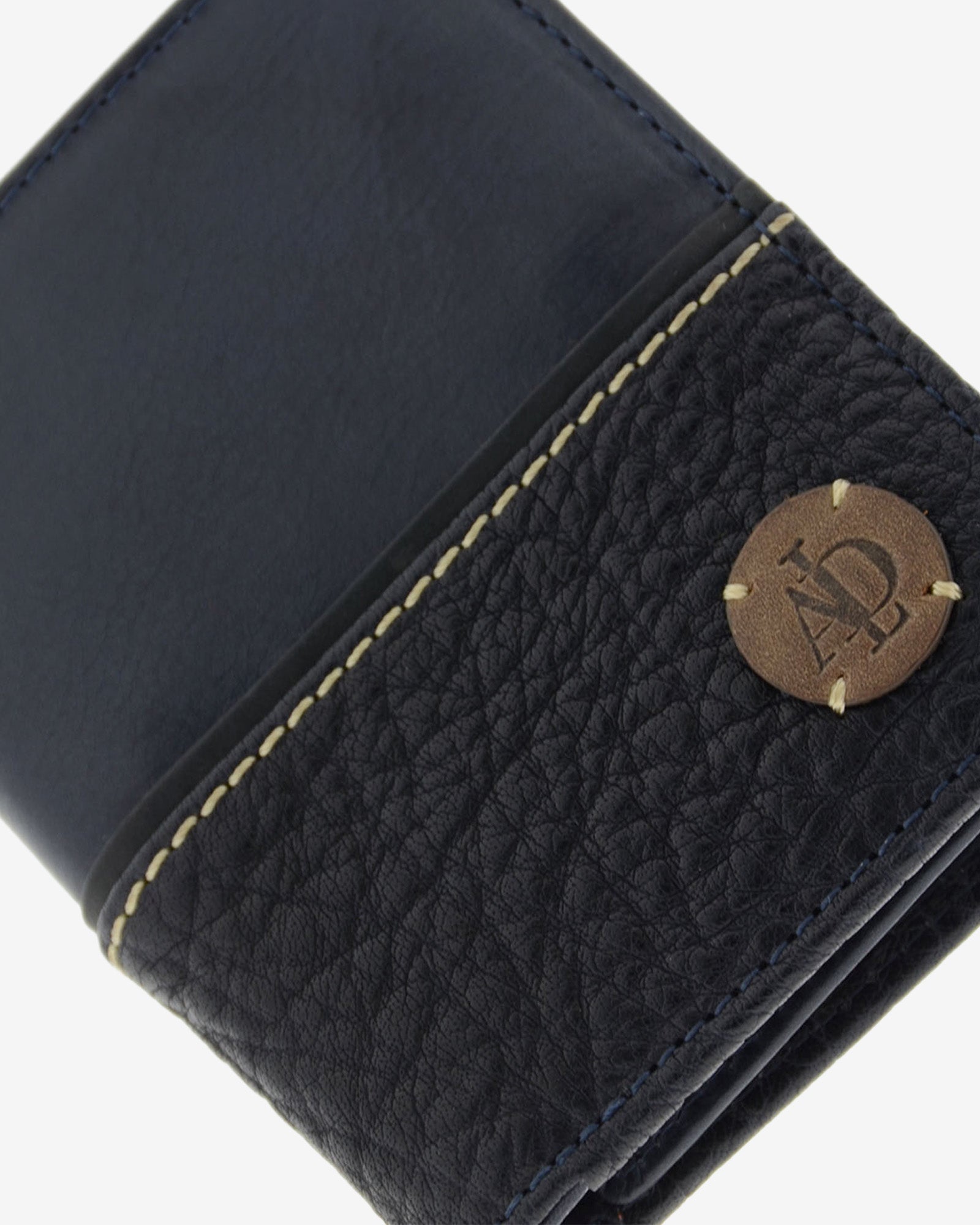 Detalle de cartera de hombre colección Rancho en piel rústica de color marino, con costura decorativa y logo circular Adapell en la parte inferior, Ref. 1606-20