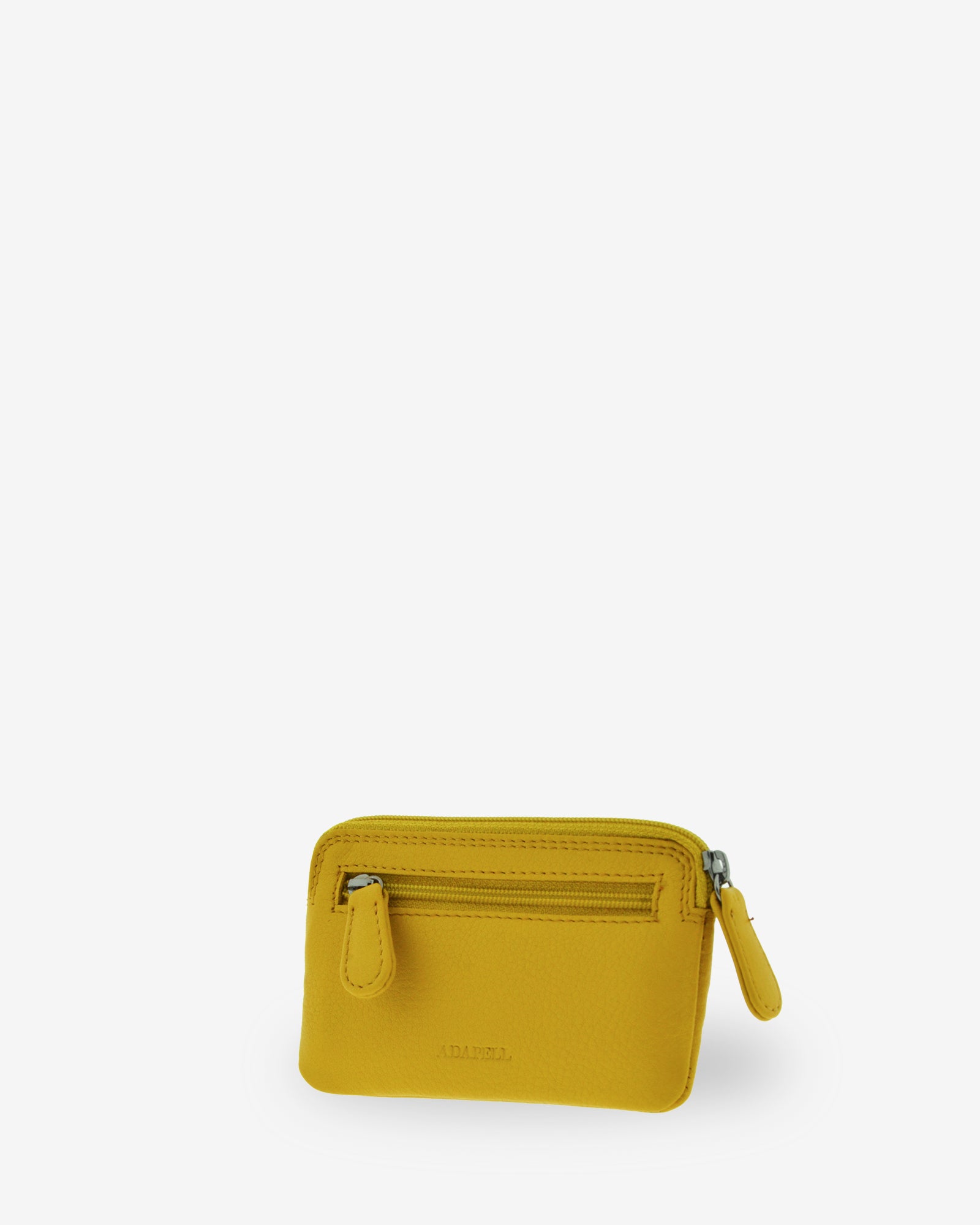 Monedero fino 8078 en color limón, vista tres cuartos posterior con bolsillo exterior de cremallera.
