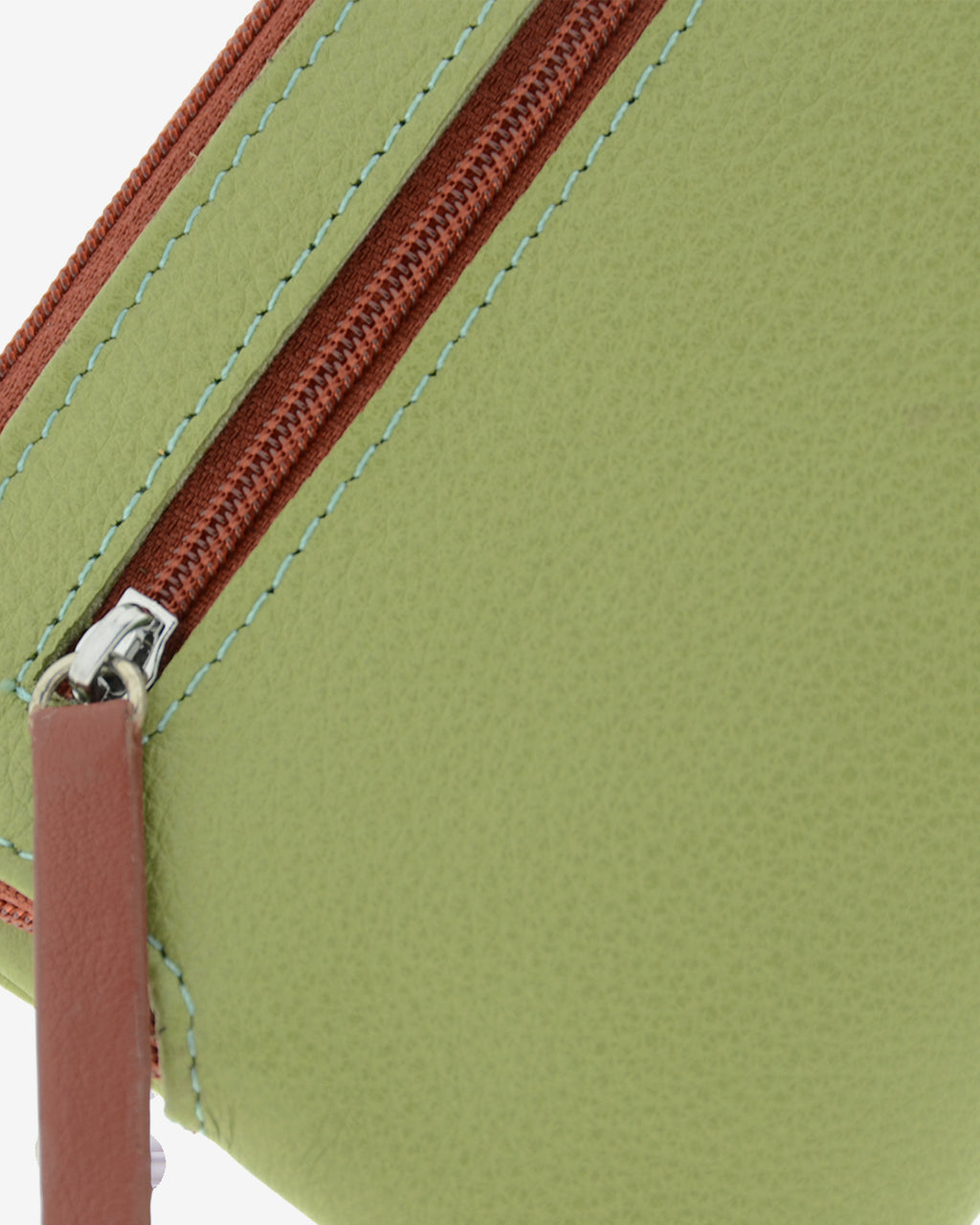 Detalle de la cremallera y acabados de la piel en la cartera pequeña de mujer Brisa color verde Sage.