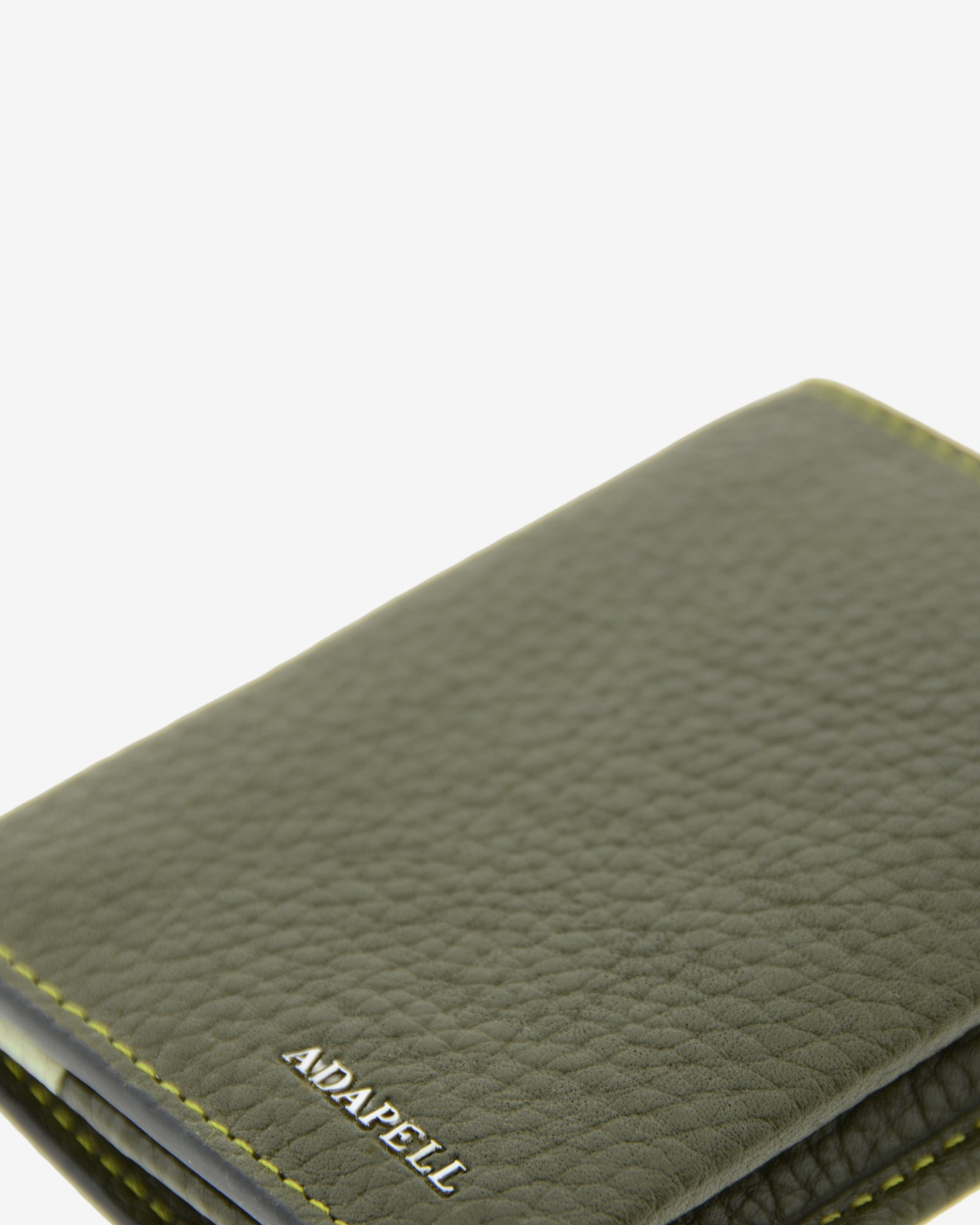 Primer plano de la piel granulada y el logo ADAPELL de la cartera vertical Nexo 1670 Verde Loden.
