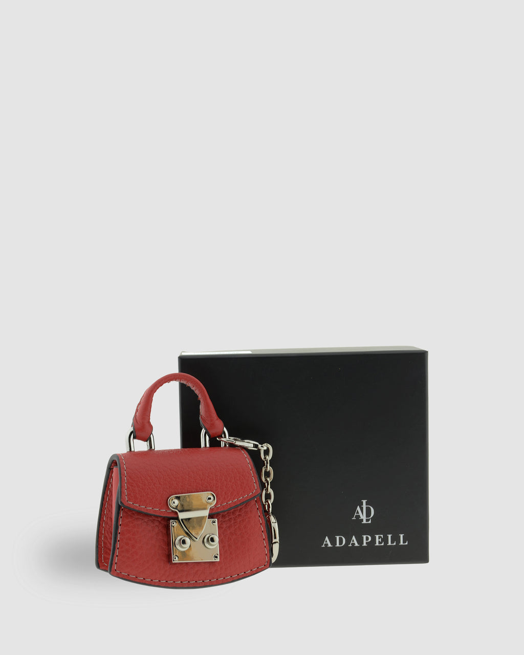 Charm para bolso con funda para auriculares Nexo 8099 amapola presentado junto a la caja Adapell