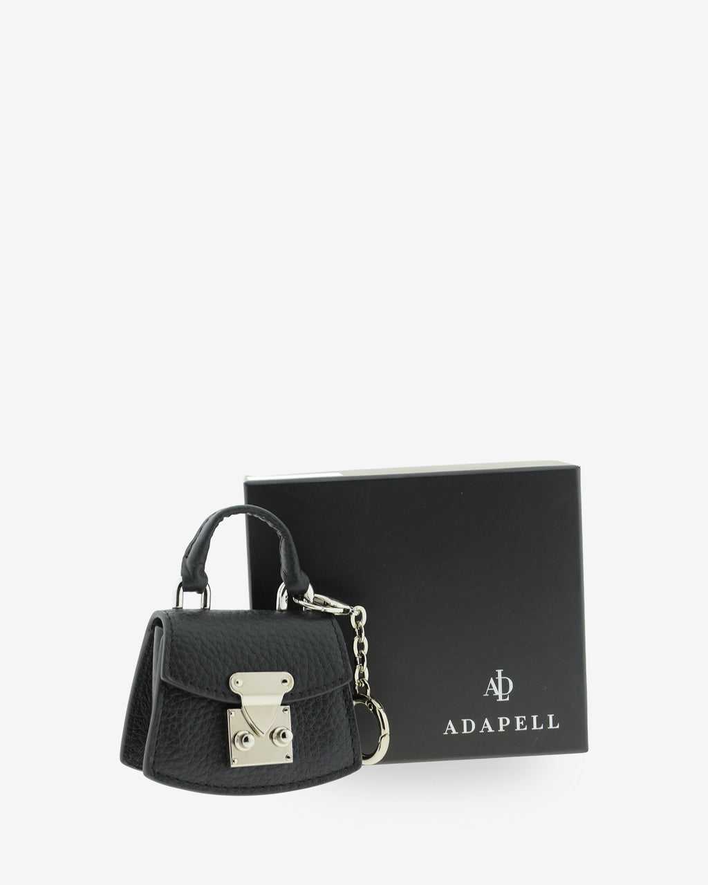 Charm para bolso con funda para auriculares Nexo 8099 negro presentado junto a la caja Adapell