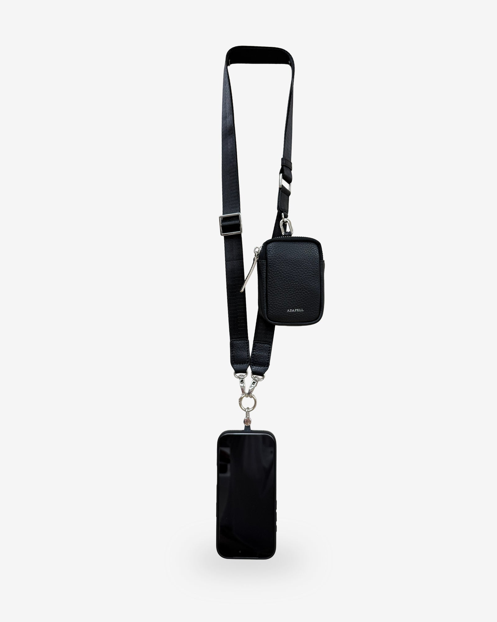 Lanyard Nexo para móvil en color negro con accesorio Nexo compatible acoplado, correa ajustable y teléfono.