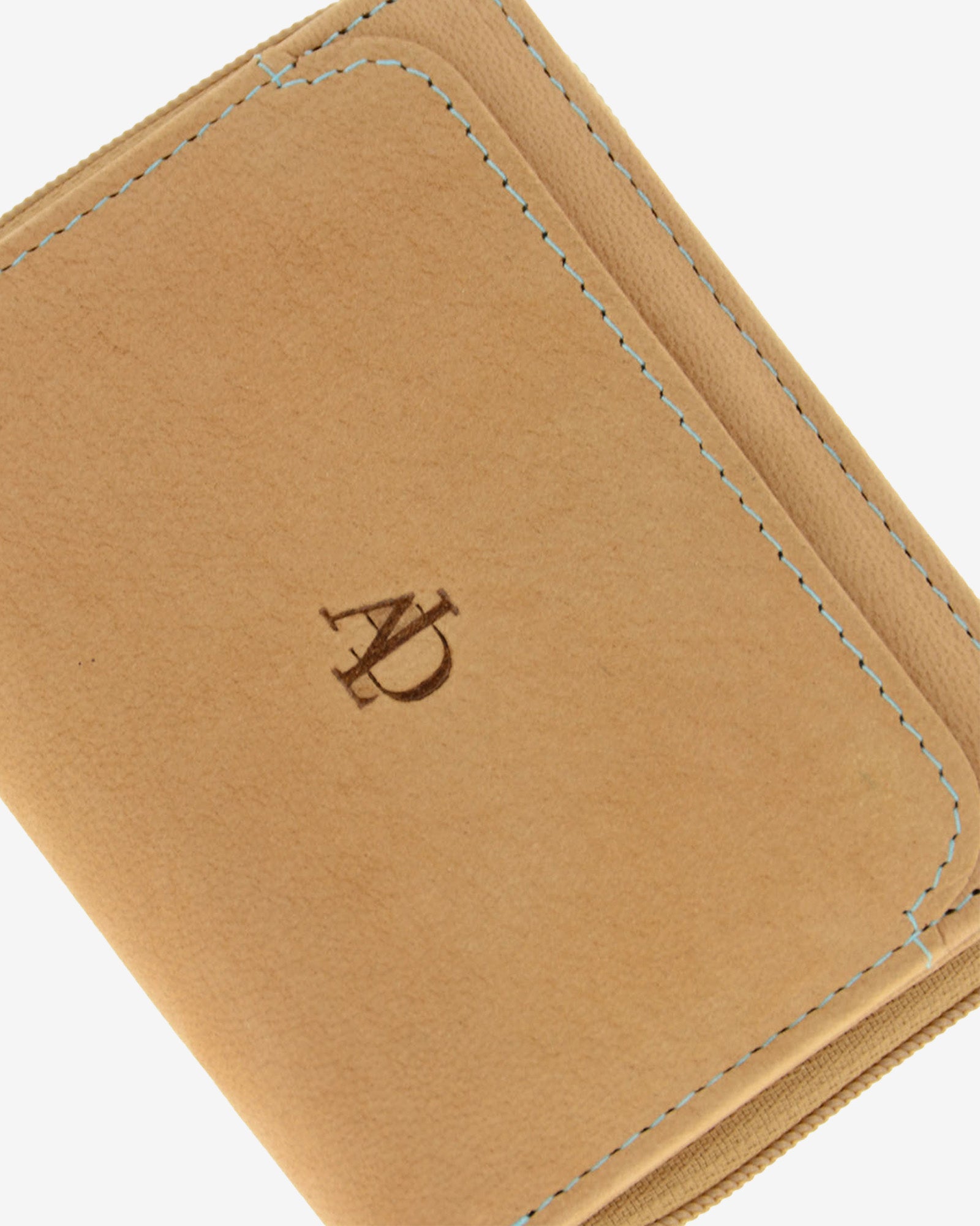 Detalle de piel color cuero con acabado tipo nobuk, logo grabado Adapell y pespunte azul en cartera compacta, 4203-6