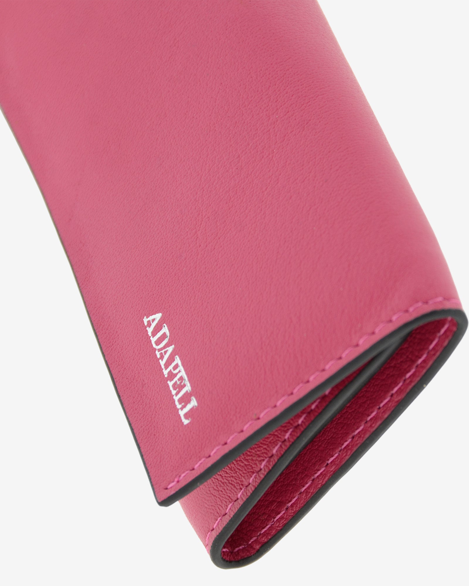 Llavero en piel auténtica de color fucsia y bordes en negro, ref. 8084-25, exterior e  interior de piel, mosquetón para 6 llaves y  compartimento exterior trasero para tarjeta, vista detalle de piel, acabados y logo